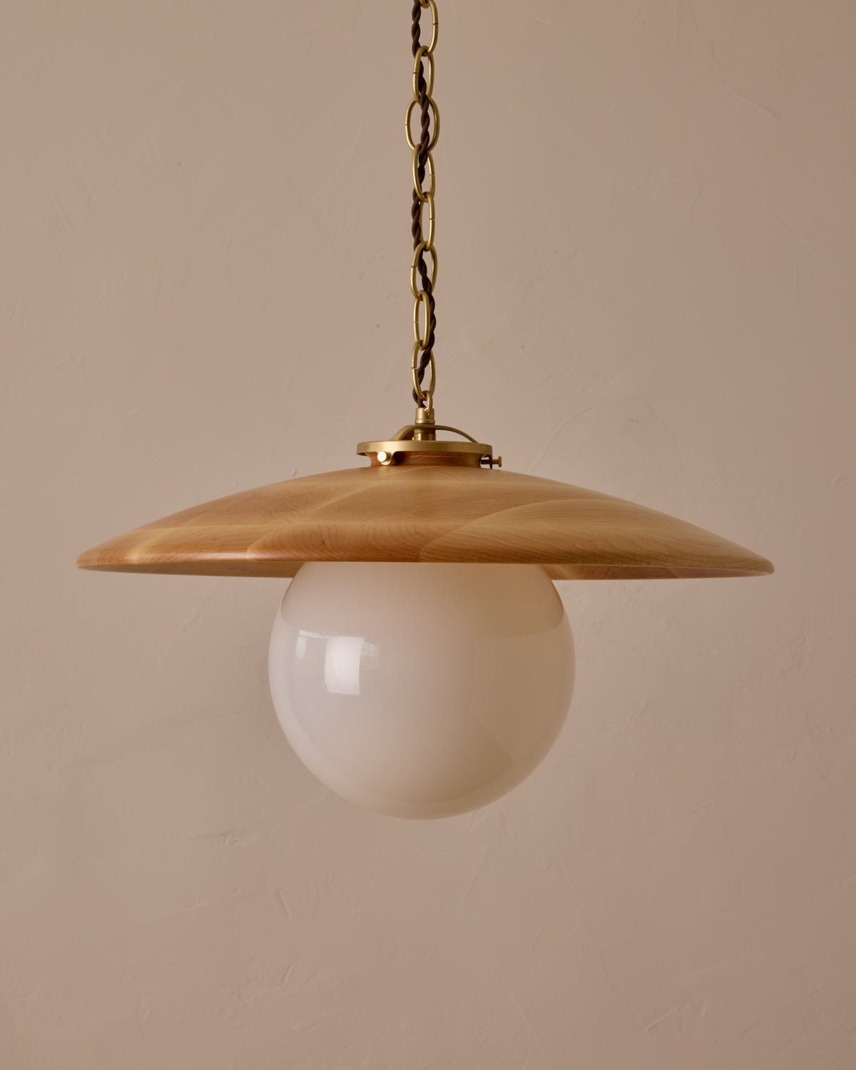 Large pendant light with oversized clear glass globe and decorative wooden clear maple shade with brass chain  #shade-finish_natural maple #globe_white glass #cord-color_brown