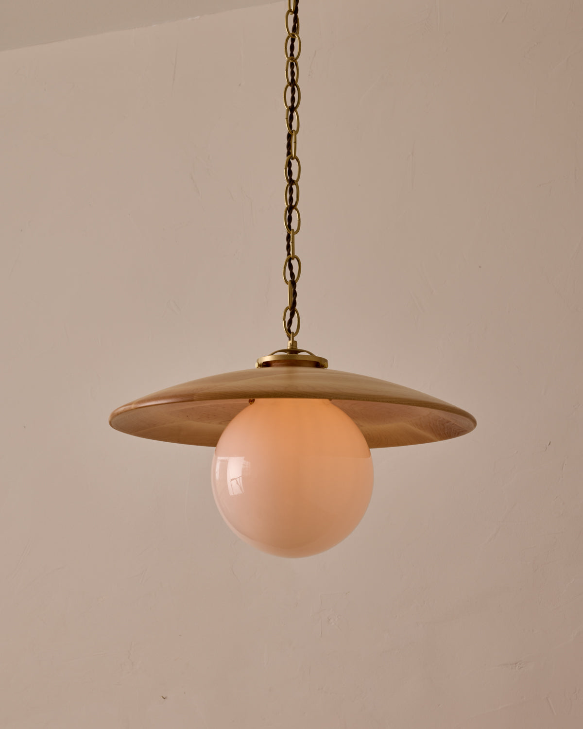 Large pendant light with oversized clear glass globe and decorative wooden clear maple shade with brass chain  #shade-finish_natural maple #globe_white glass #cord-color_brown