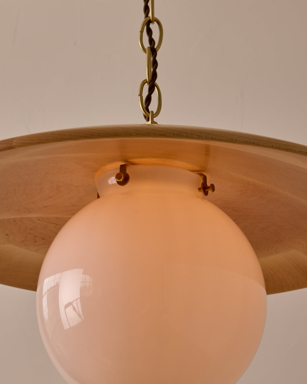 Large pendant light with oversized clear glass globe and decorative wooden clear maple shade with brass chain  #shade-finish_natural maple #globe_white glass #cord-color_brown