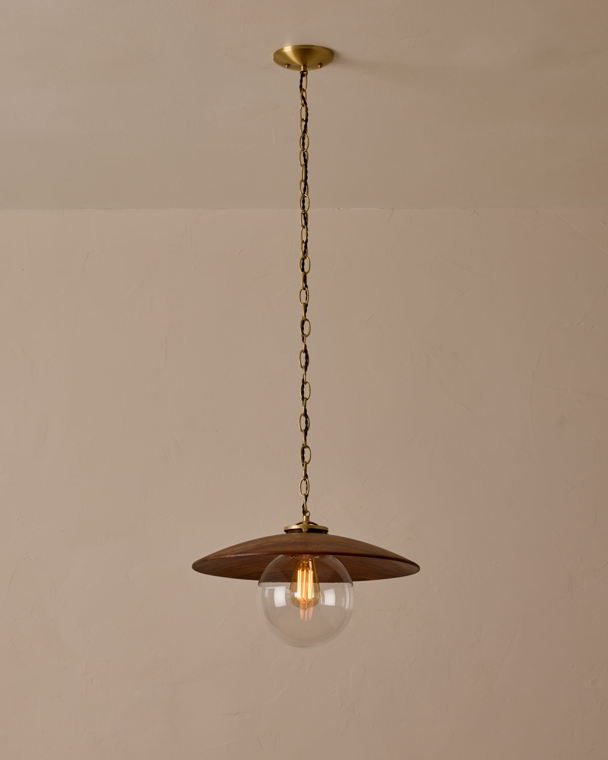 Large pendant light with oversized clear glass globe and decorative wooden clear maple shade with brass chain  #shade-finish_black walnut #globe_clear glass #cord-color_brown