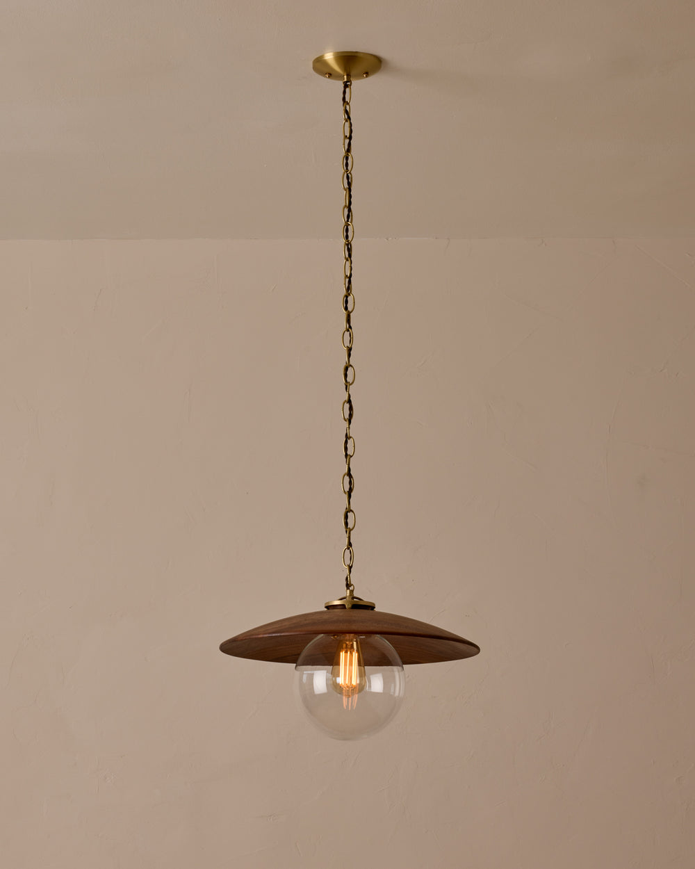 Large pendant light with oversized clear glass globe and decorative wooden clear maple shade with brass chain  #shade-finish_black walnut #globe_clear glass #cord-color_brown