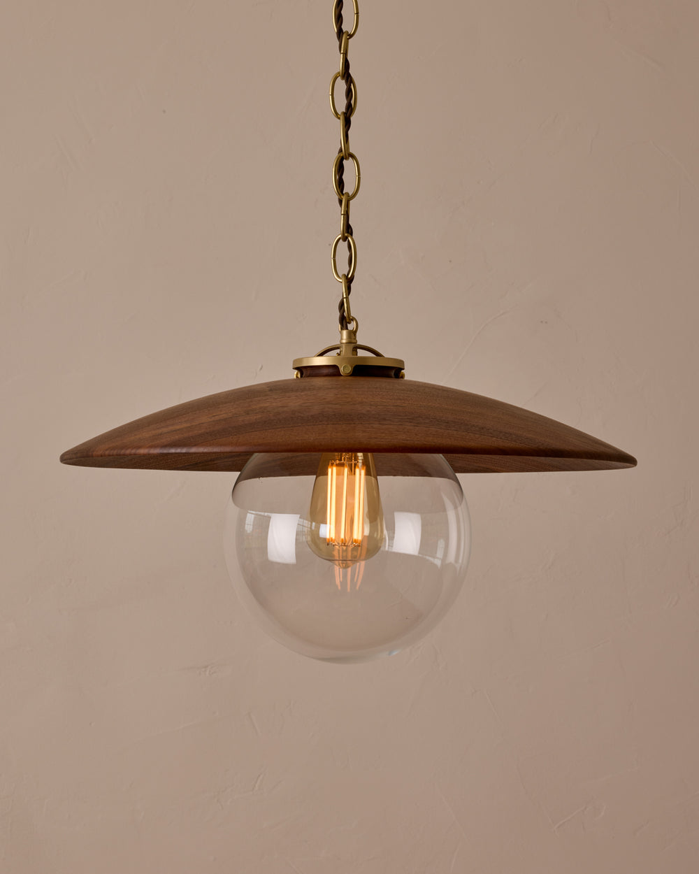 Large pendant light with oversized clear glass globe and decorative wooden clear maple shade with brass chain  #shade-finish_black walnut #globe_clear glass #cord-color_brown