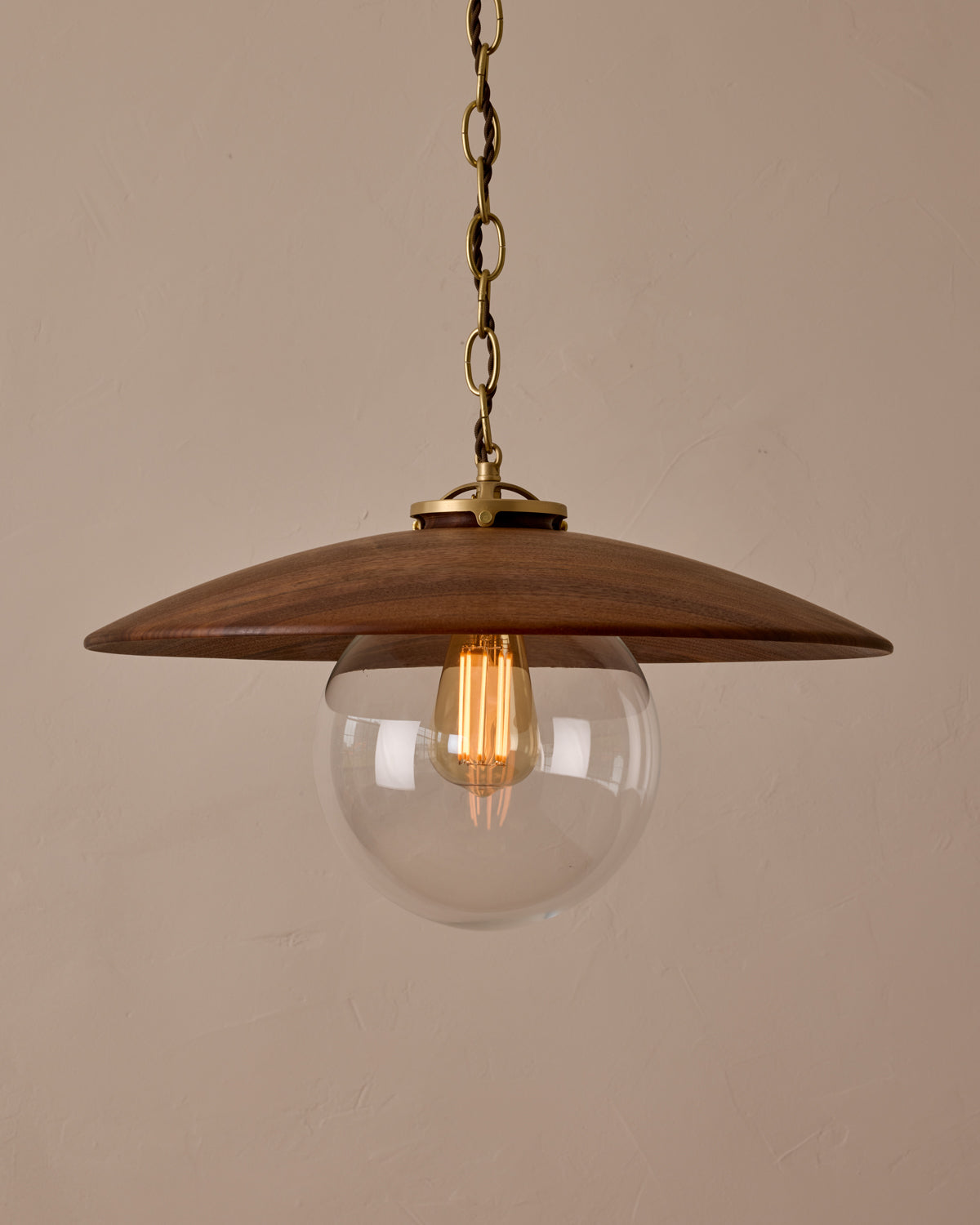 Large pendant light with oversized clear glass globe and decorative wooden clear maple shade with brass chain  #shade-finish_black walnut #globe_clear glass #cord-color_brown