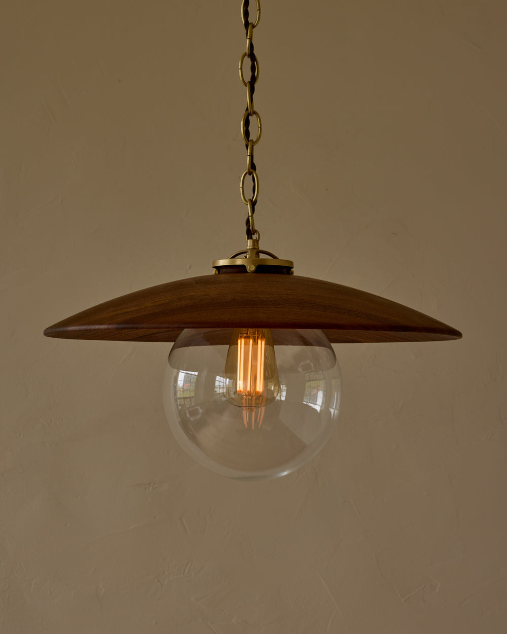 Large pendant light with oversized clear glass globe and decorative wooden clear maple shade with brass chain  #shade-finish_black walnut #globe_clear glass #cord-color_brown