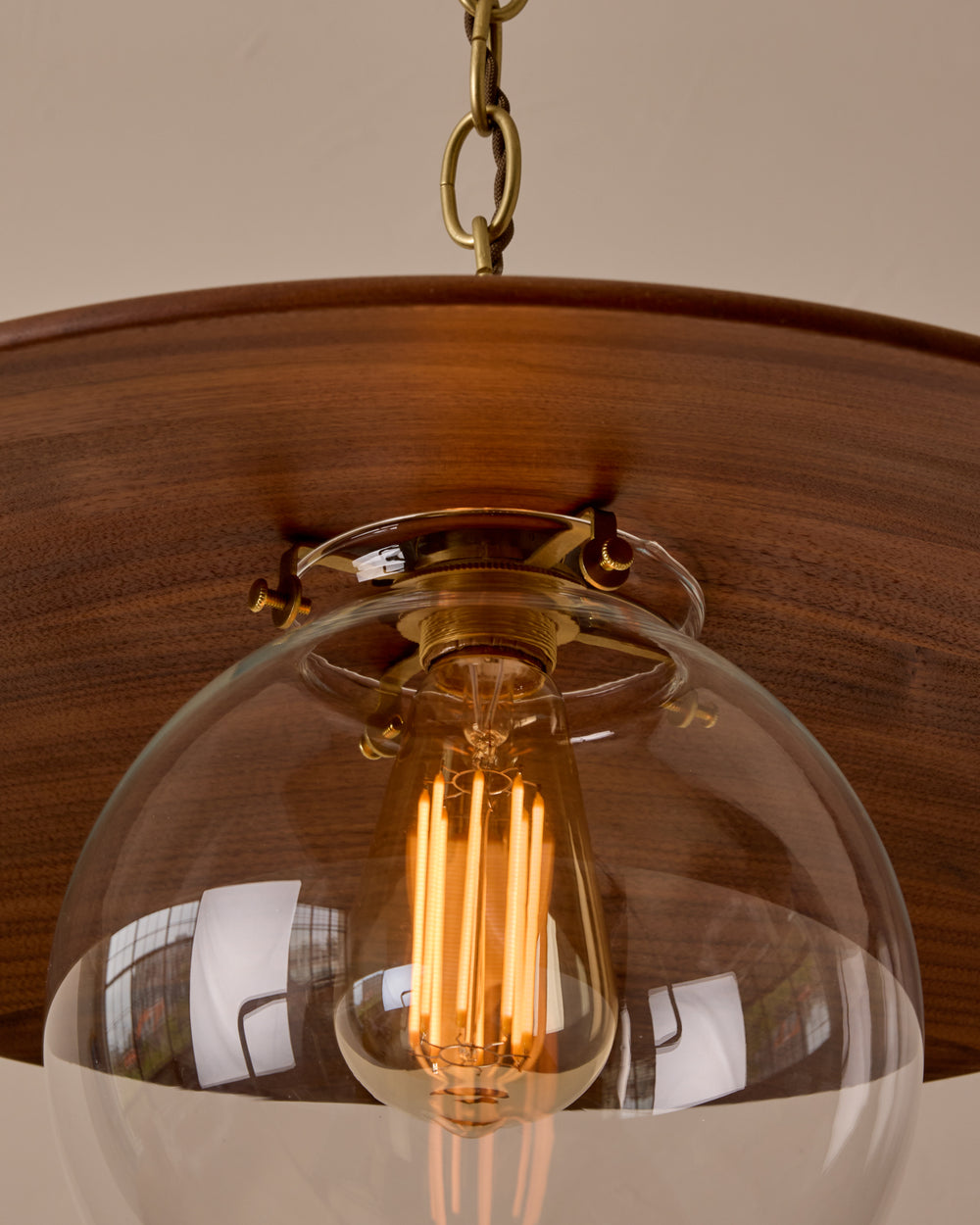 Large pendant light with oversized clear glass globe and decorative wooden clear maple shade with brass chain  #shade-finish_black walnut #globe_clear glass #cord-color_brown