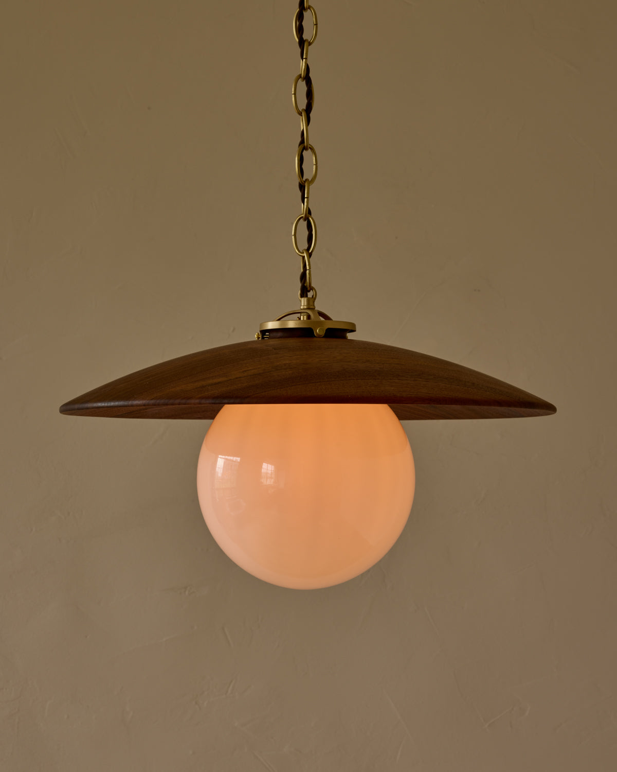 Large pendant light with oversized clear glass globe and decorative wooden clear maple shade with brass chain  #shade-finish_black walnut #globe_white glass #cord-color_brown