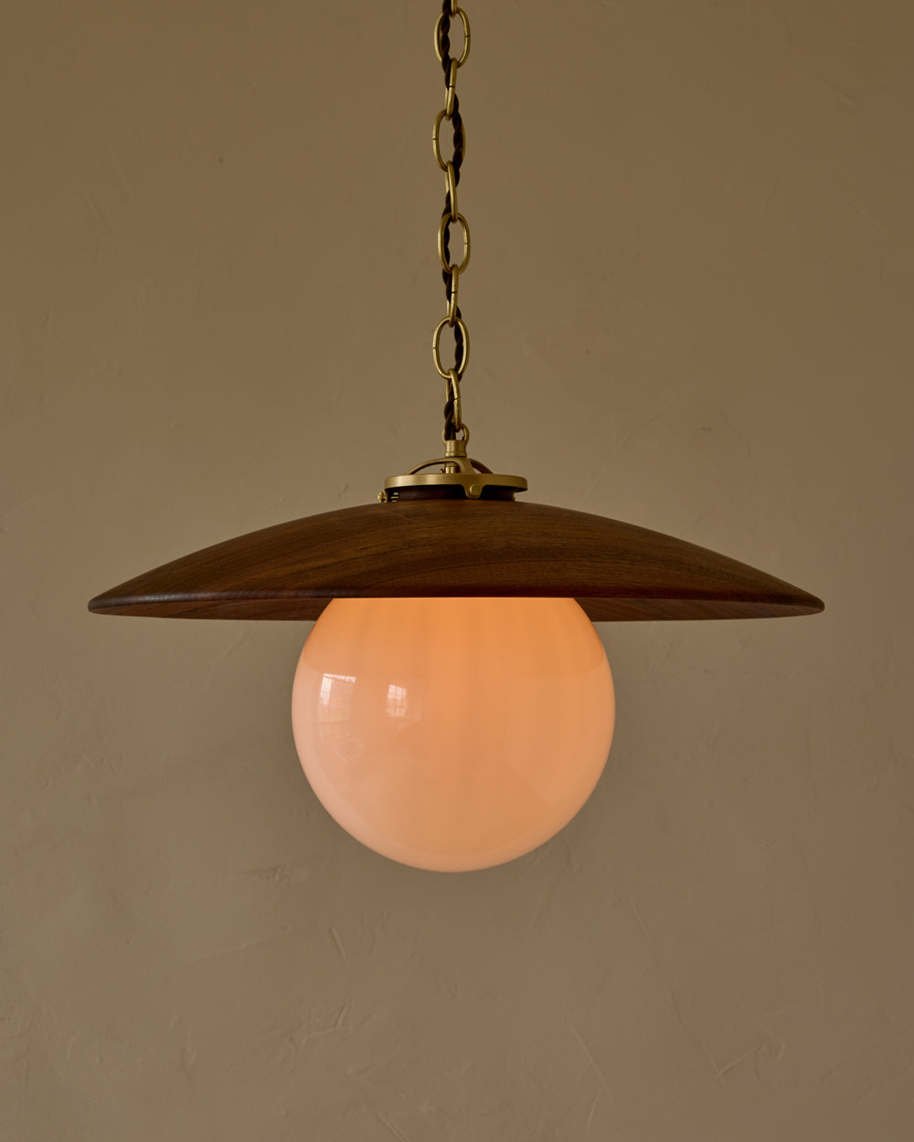 Large pendant light with oversized clear glass globe and decorative wooden clear maple shade with brass chain  #shade-finish_black walnut #globe_white glass #cord-color_brown