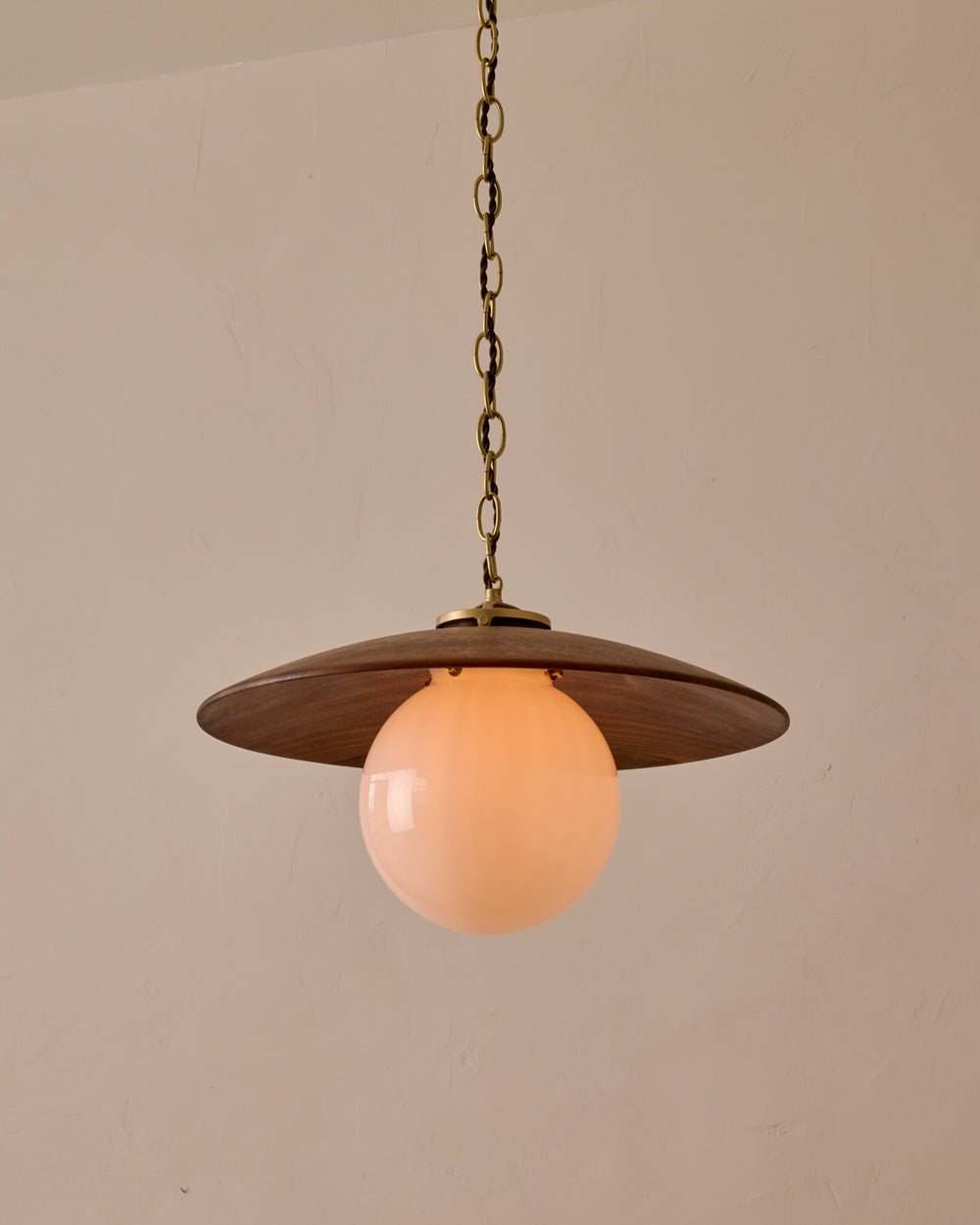 Large pendant light with oversized clear glass globe and decorative wooden clear maple shade with brass chain  #shade-finish_black walnut #globe_white glass #cord-color_brown
