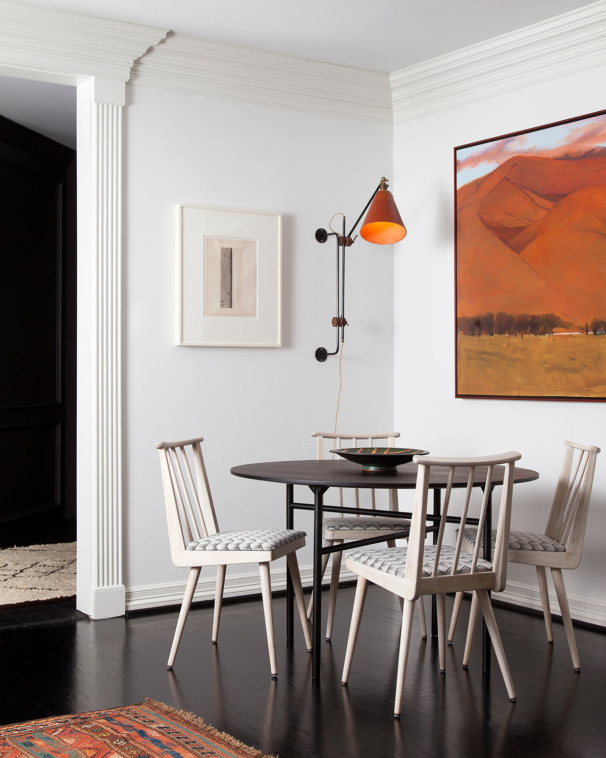 Large articulating black plug in wall sconce with tan handstitched cone leather shade in dining room #shade-finish_tan harness #wiring_plug-in