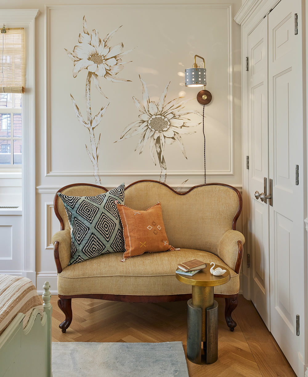 Articulating satin brass sconce with blue handstitched shade and walnut backplate in sitting room  #leather-finish_cloud blue #wiring_plug-in