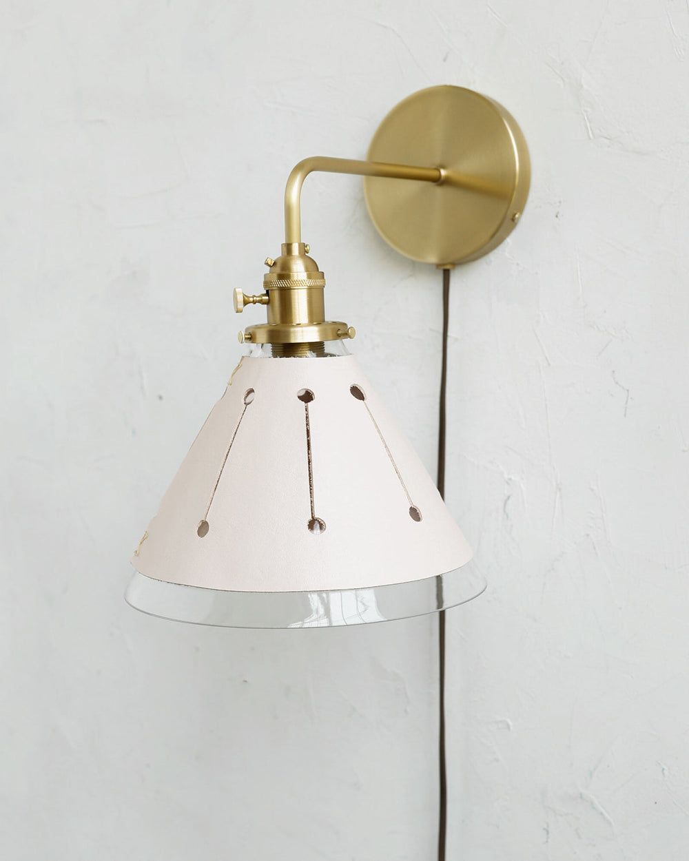 Classic satin brass plug in wall sconce with cone glass diffuser and decorative handstitched leather shade #leather-finish_dogwood #wiring_plug-in