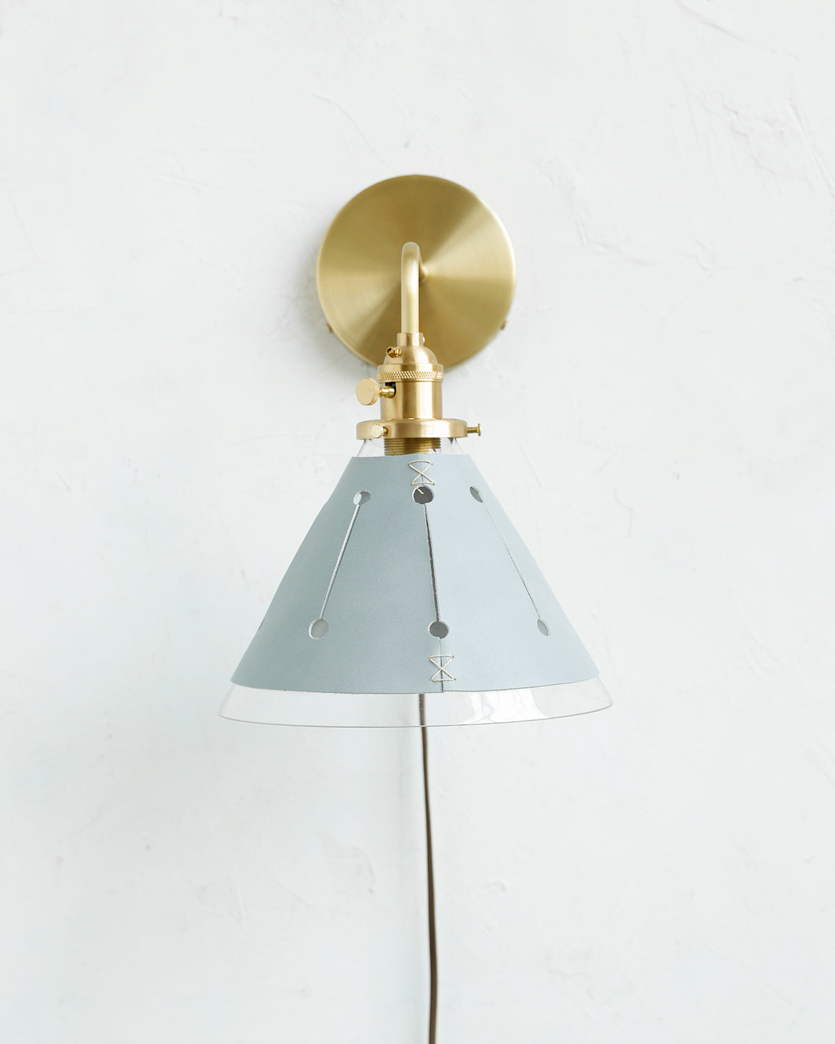 Classic satin brass plug in wall sconce with cone glass diffuser and decorative handstitched leather shade #leather-finish_cloud blue #wiring_plug-in