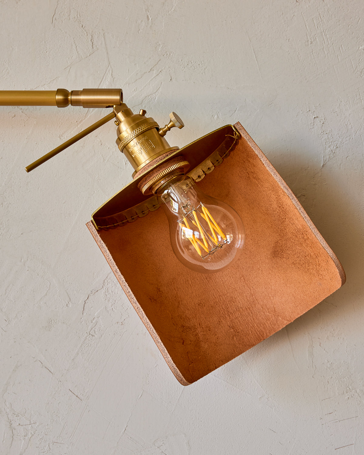 Curved tan leather and brass shade for articulating wall sconce #leather-finish_tan harness