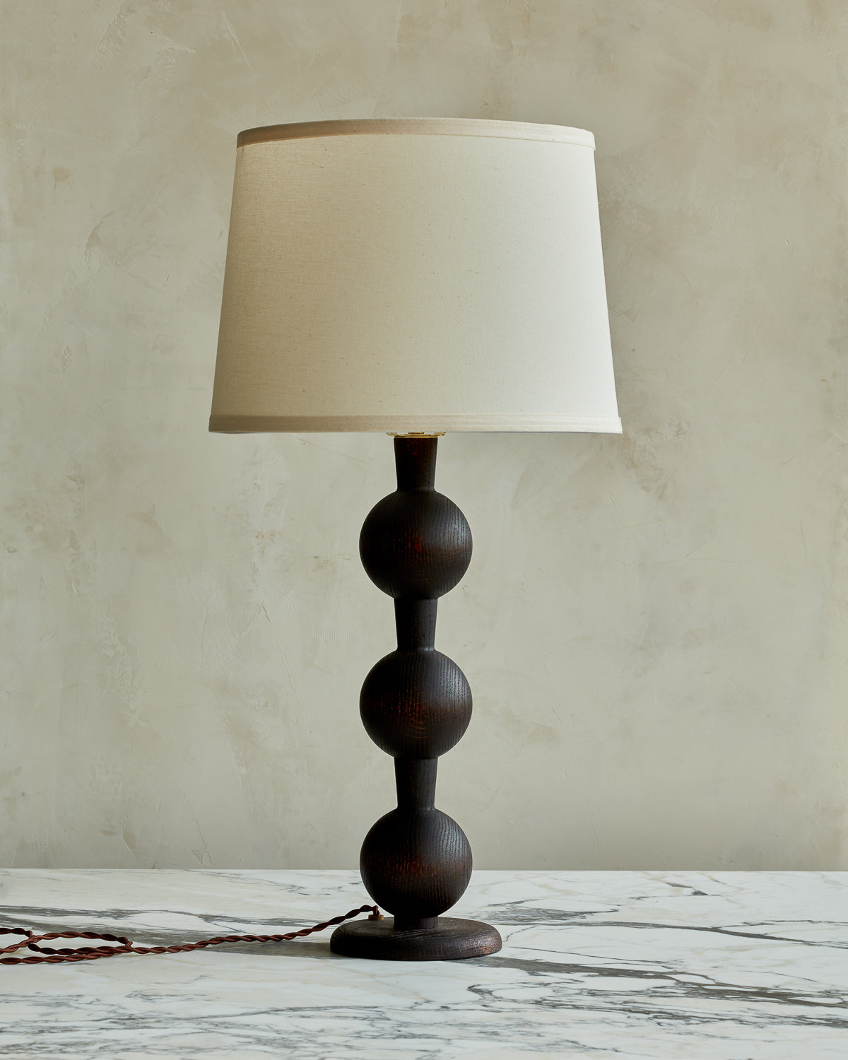 Sculptural solid wood table lamp with barbell design in dark wash finish with ivory linen shade #wood-finish_dark wash red oak #shade-color_ivory linen