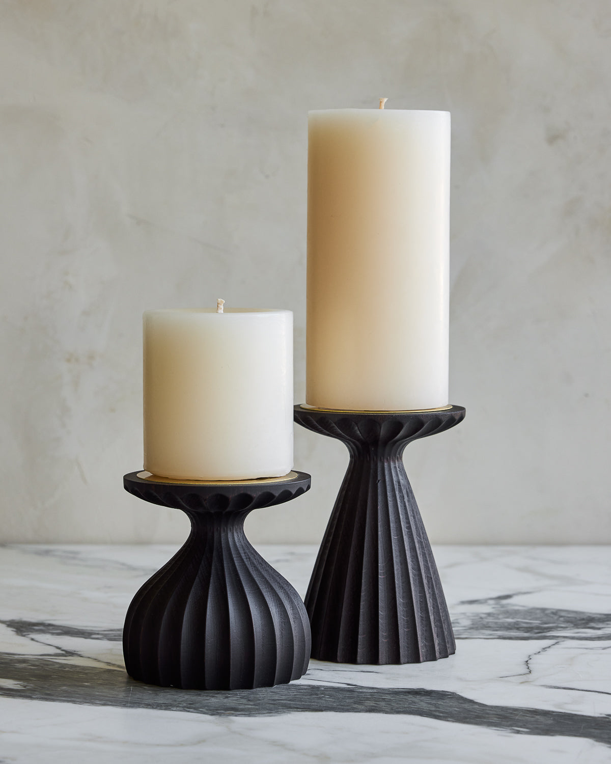 Pair of delicately grooved pillar candle holders in dark wash maple wood with shell white pillar candles #wood-finish_dark wash maple