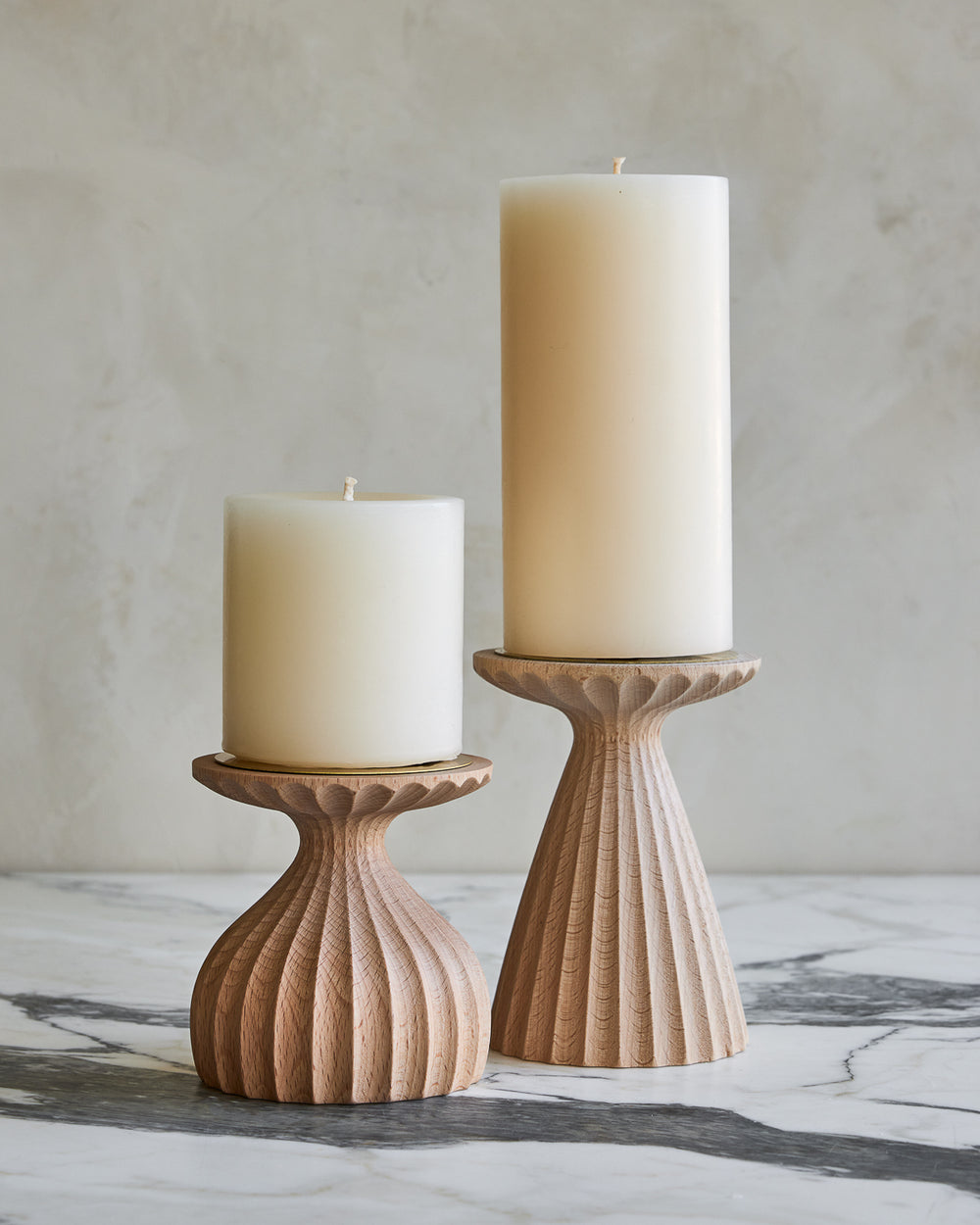 Pair of delicately grooved pillar candle holders in natural maple wood with shell white pillar candles #wood-finish_natural maple
