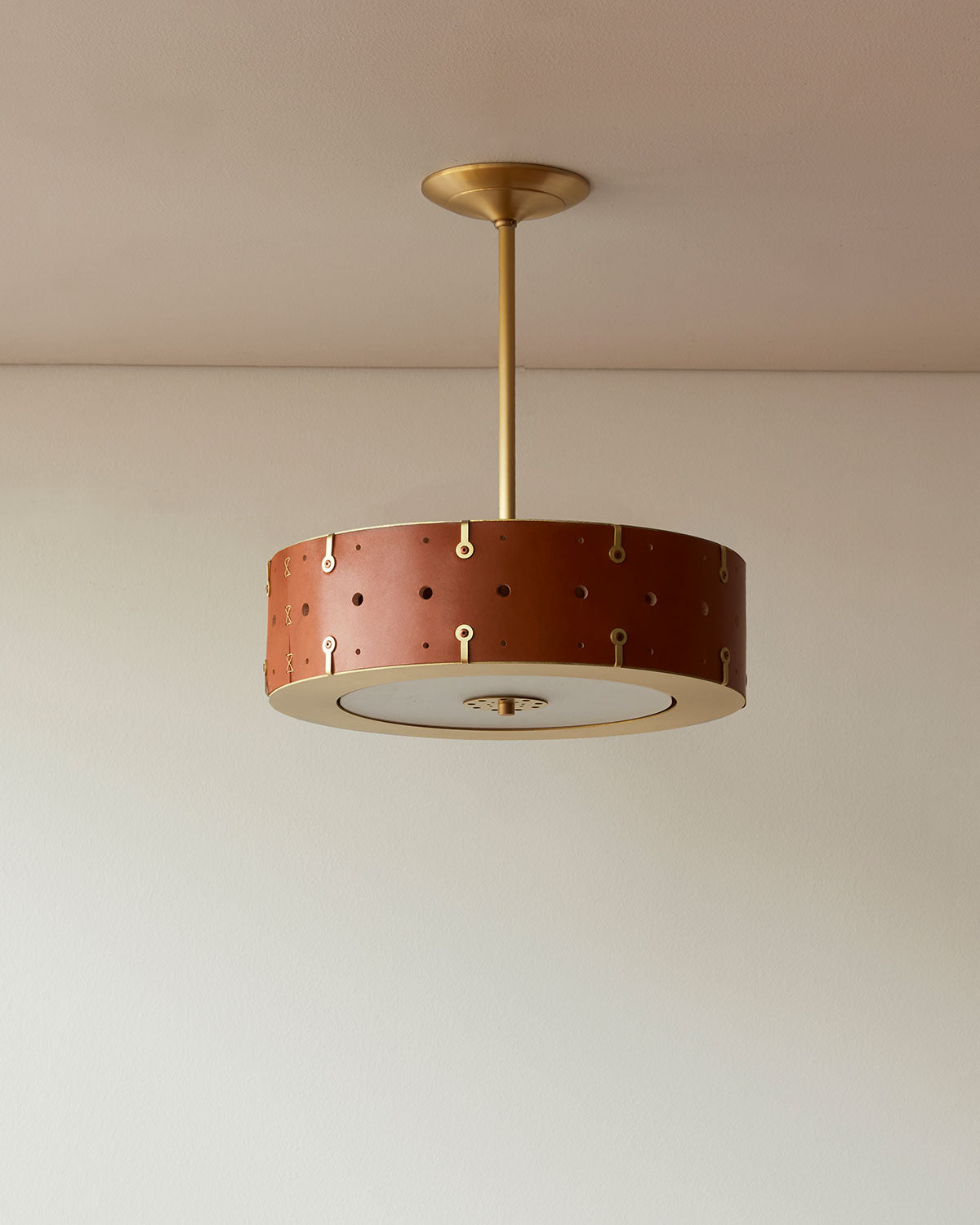 Beautiful satin brass ceiling pendant fixture with handstitched leather drum shade and customizable drop
#leather-color_tan harness #size_14" drum